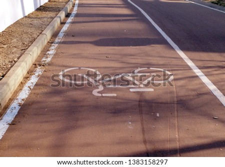 The marking on the track in the park in the form of a bicycle