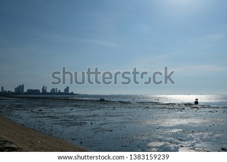 Beach and sea with city at the horizon as the background