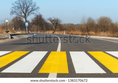 white yellow markings on the road, pedestrian crossing outside the city