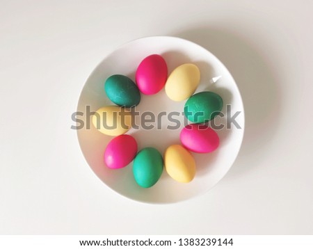 colorful Easter eggs on a white plate