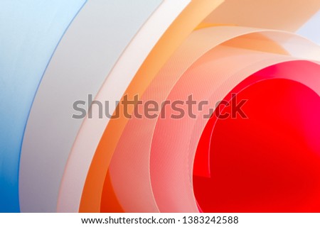 Art photography - background of multi-colored glossy sheets.