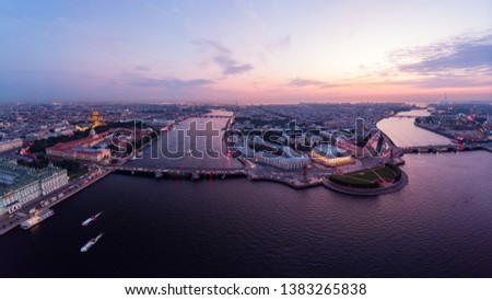 Beautiful aerial evning view in the white nights of St. Petersburg, Russia, The Vasilievskiy Island at sunset, Rostral Columns, Admiralty, Palace Bridge, Stock Exchange Building. shot from drone
