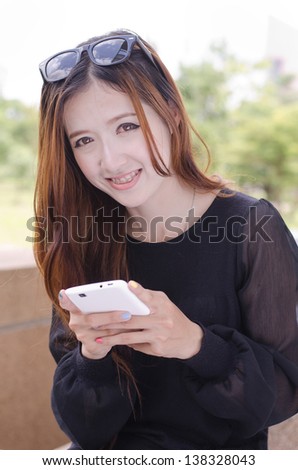 Close up beautiful young woman using a mobile phone