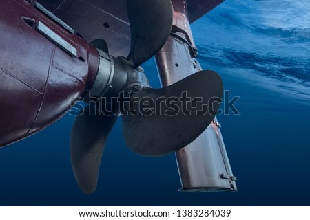 Propeller and rudder of big ship underway from underwater. Close up image detail of ship. Transportation industry. Freight transportation. Ship repair, underwater survey and shipping business concept Royalty-Free Stock Photo #1383284039