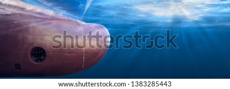 Big cargo ship sailing in the sea to Shipping container terminal. Close up image detail ships bow, underwater view. Shipping business and underwater survey concept. Hull maintenance and inspection. Royalty-Free Stock Photo #1383285443