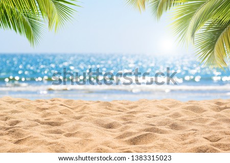 Abstract seascape with palm tree, tropical beach background. blur bokeh light of calm sea and sky. summer vacation background concept.