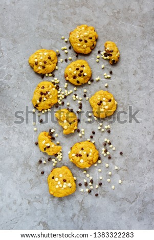 Flat lay of delicious dark and white chocolate chip cookies on vintage concrete background - Image