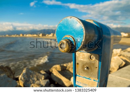 tourist binoculars on the dock, directed towards the sea 