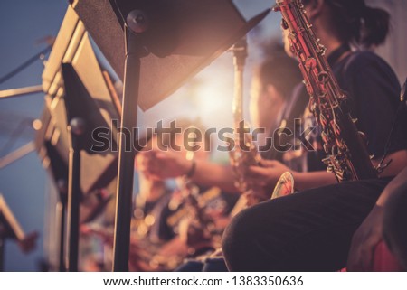Alto sax musical instrument closeup,jazz musician playing outdoor concert 