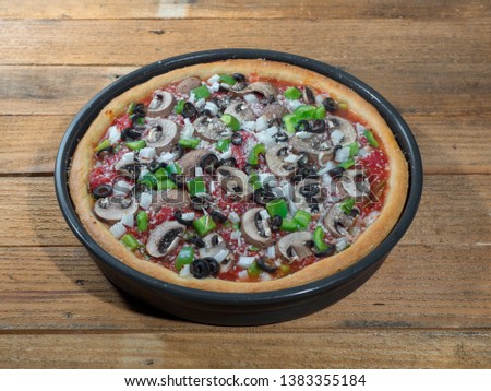 Stock photo of a deep dish Chicago pizza with sauce, cheese, and mushrooms. 