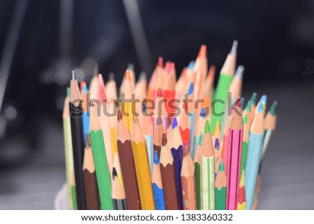 close up of colorful set wooden color pencil in isolated black and blur  background.