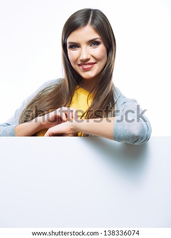 Teenager girl with white blank board. White background isolated portrait of smiling young woman.