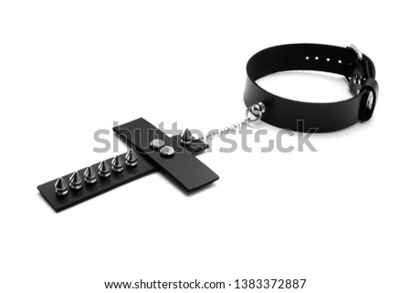 Black leather collar with a large cross with spikes. Isolated on white background. Side view