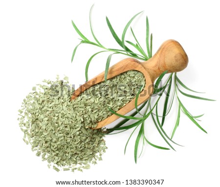 dried tarragon in the wooden scoop, isolated on white background, top view