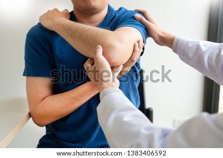 Physiotherapist working concept, Doctor and patient suffering or Chiropractor examining from shoulder pain in clinic medical office Royalty-Free Stock Photo #1383406592