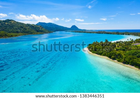 Aerial drone view of French Polynesia Tahiti island Huahine and Motu coral reef lagoon and Pacific Ocean. Tropical paradise. Royalty-Free Stock Photo #1383446351