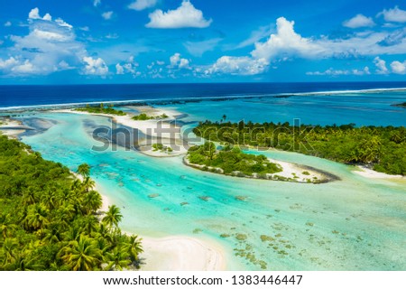 Rangiroa aerial drone video of atoll island motu and coral reef in French Polynesia, Tahiti. Amazing nature landscape with blue lagoon and Pacific Ocean. Tropical island paradise in Tuamotus Islands. Royalty-Free Stock Photo #1383446447