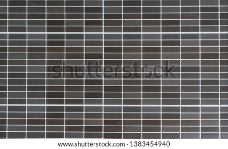 Seamless modern brown/grey small mosaic tiles texture pattern background.
