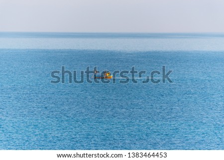 Tiny Fishing Boat on the Southern Italian Mediterranean Sea at Sunrise