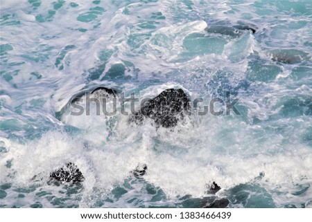 Spraying wave crashing over rocks at Penguin Parade, Australia