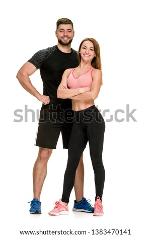 Fit happy couple: strong muscular man and slim woman posing on white background Royalty-Free Stock Photo #1383470141