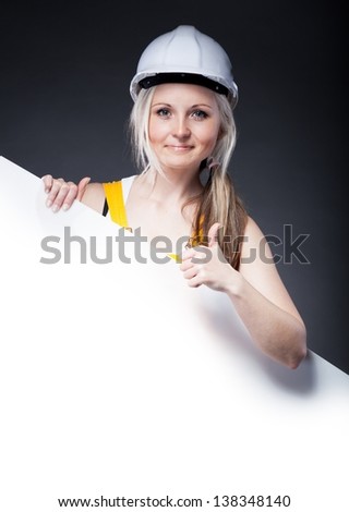 Young architect woman construction worker and empty frame