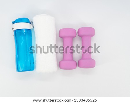 Fitness equipment with dumbbells, drinking water bottle and towel isolated on a white background. Healthy with exercise concept. Top view from above.
