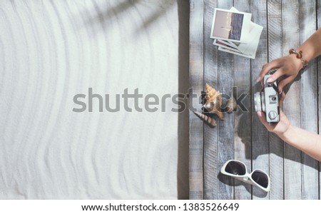Woman lying on the beach deck and taking pictures, summer vacations and leisure concept, blank copy space