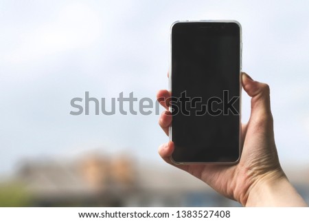 Phone in hand, female hand. The girl holds the phone. Take a photo, selfie. To answer the call.