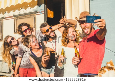 Alternative millennial young caucasian people group of friends taking selfie picture outside in sunny day outdoor leisure activity celebrate together with beer and lot of fun and laughs