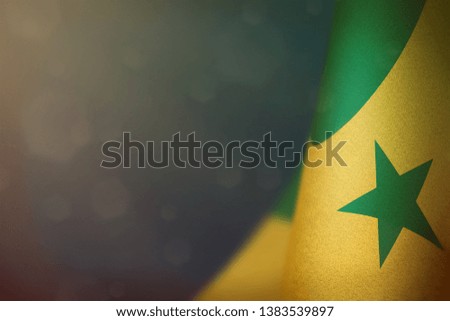 Senegal hanging flag for honour of veterans day or memorial day on light blue dark velvet background. Senegal glory to the heroes of war concept.