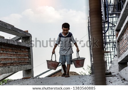 Children working at construction site for world day against child labor concept: Royalty-Free Stock Photo #1383560885