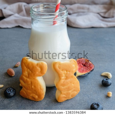 Healthy breakfast meal for the whole family / Healthy Breakfast / Animated shaped bread eaten with raw wild bee honey, milk, fresh figs, blueberries, kiwi berries, almonds, chickpeas and cashew nuts