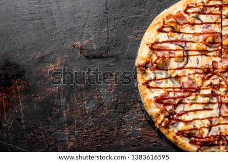 Fragrant barbecue pizza. On dark rustic background