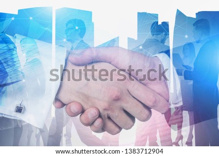 Close up of two businessmen shaking hands over abstract city background with business people and telecommunication hologram. Toned image double exposure
