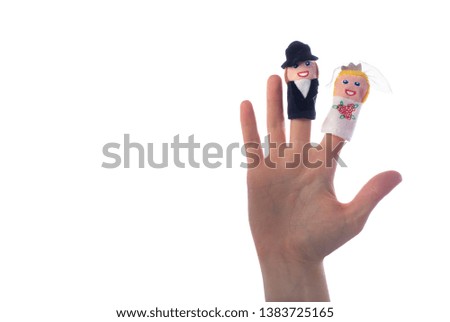 Figures of the toys of women and the bride on the fingers. White isolated background. Place for your lettering.