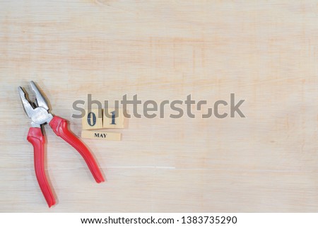 Top view of handy tools with May 1 text wooden block calendar on light wooden board background with copy space for your text for Worker day, Labor day, labour day.