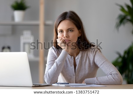 Bored young woman sit at home office table look in distance unable to work at laptop, exhausted girl student feel unmotivated unwilling to study, distracted taking break. Dull monotonous job concept Royalty-Free Stock Photo #1383751472