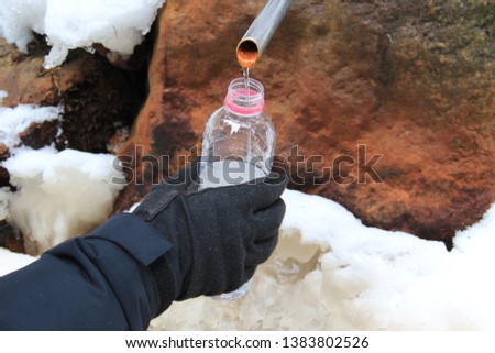 Pouring fresh mountain water into a cup/bottle.
