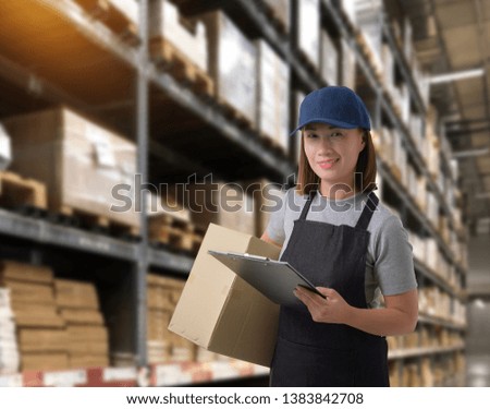 Female staff Delivering products Sign the signature on the product receipt form with parcel boxes Blurred the background of the warehouse
