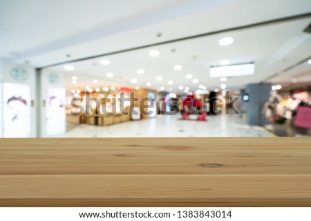 Empty wooden table space platform and blurred shopping mall 