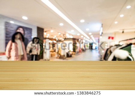 Empty wooden table space platform and blurred shopping mall 