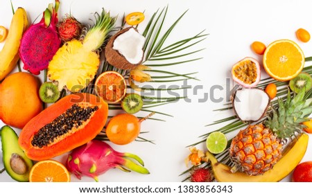 Still life with fresh assorted exotic fruits on a palm leaf. Concept of healthy eating with fruits. Top view.
