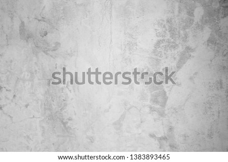 Wall fragment with scratches and cracks. Textured weathered black and white handmade surface for background.