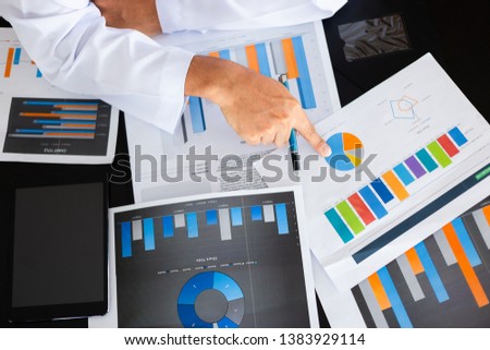 Selective focus at hand of  businessman and paperwork on desk in office, muslim businessman concept