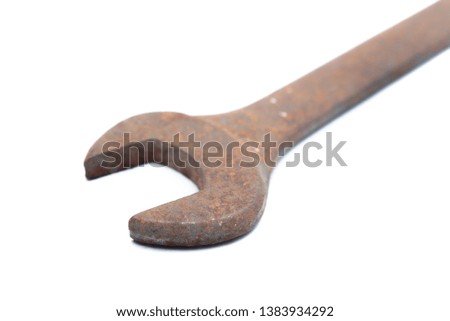 Old rusty wrench isolated on white background. 