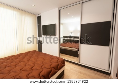 Simple bedroom interior with large comfortable bed. Interior photography