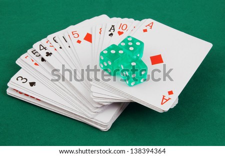Dices and cards on green table