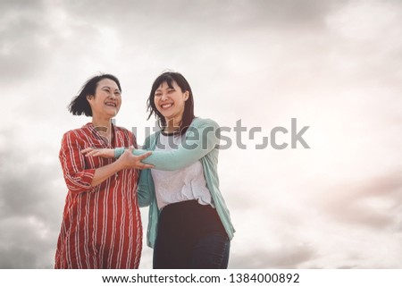 Asian mother and daughter having fun outdoor - Happy Chinese family  enjoying time together outside - Happiness, love, parenthood and people lifestyle concept 
