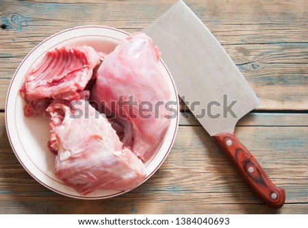 Raw rabbit meat on a platter in the kitchen to be cooked 
